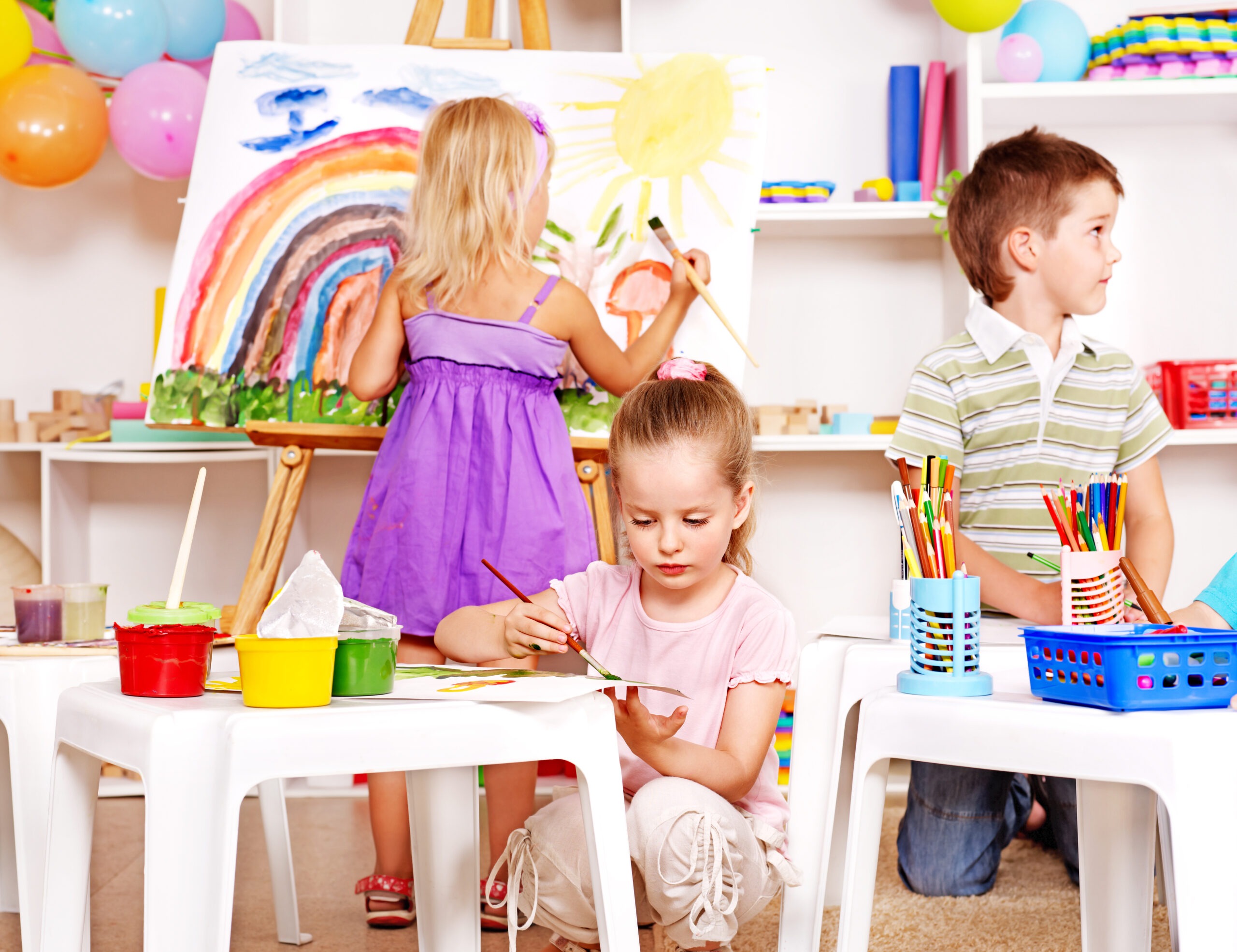 Group Children Painting at Easel in School