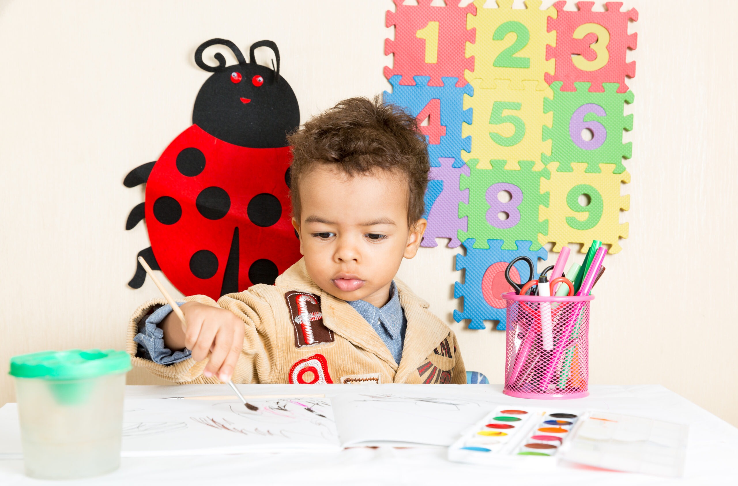 African American Black Boy Drawing with Colorful Pencils